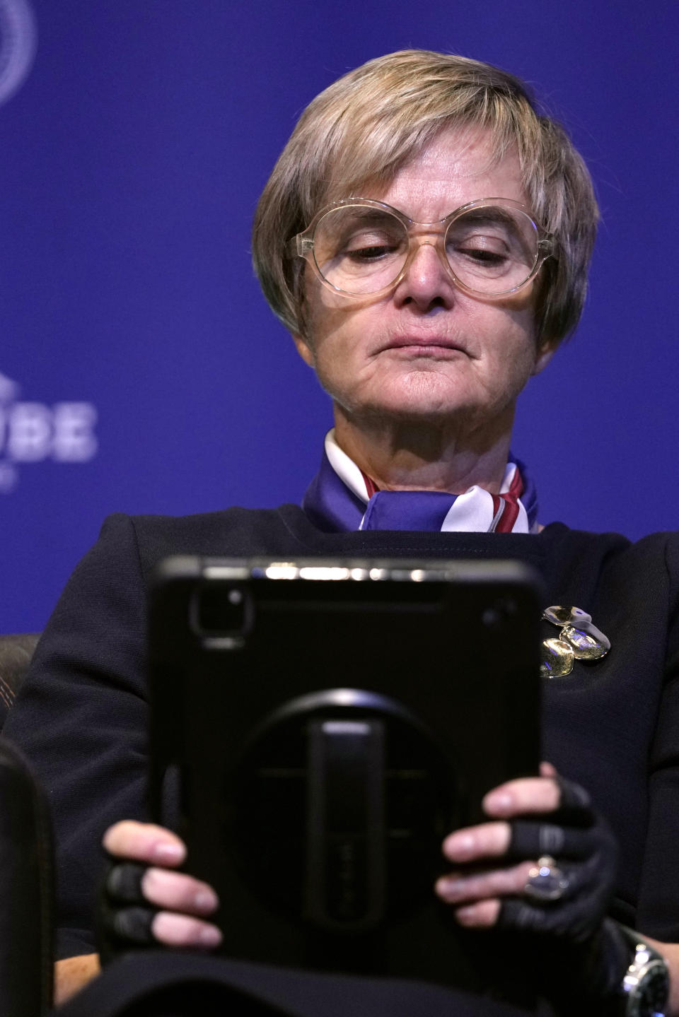 Activist Gloria von Thurn-und-Taxis looks at her electronic device as she attends the National Conservatism conference in Brussels, Wednesday, April 17, 2024. (AP Photo/Virginia Mayo)