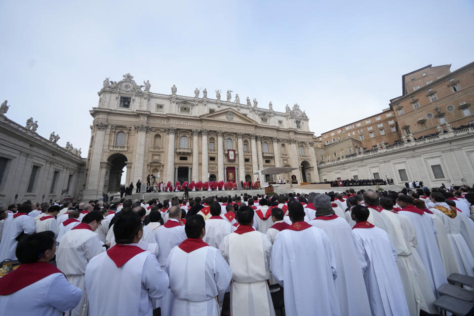 Priests stand during the funeral mass for late Pope Emeritus Benedict XVI in St. Peter's Square at the Vatican, Thursday, Jan. 5, 2023. Benedict died at 95 on Dec. 31 in the monastery on the Vatican grounds where he had spent nearly all of his decade in retirement. (AP Photo/Andrew Medichini)