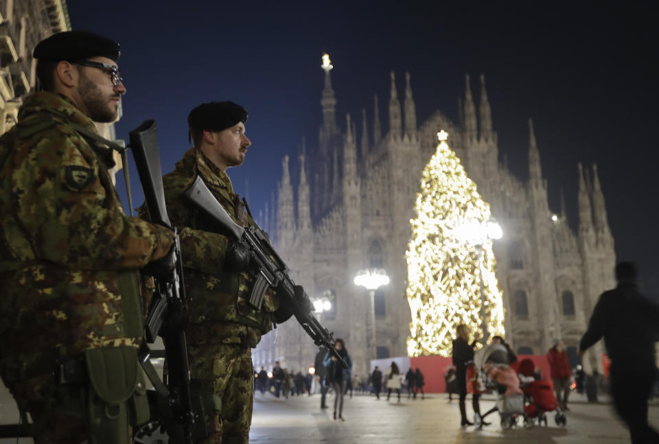Italian soldiers patrol next to Milan's gothic cathedral, Italy, Thursday, Dec. 22, 2016. Following the truck attack on a Christmas market in Berlin, Italy is strengthening security measures for areas where crowds are expected for Christmas ceremonies. (AP Photo/Luca Bruno)