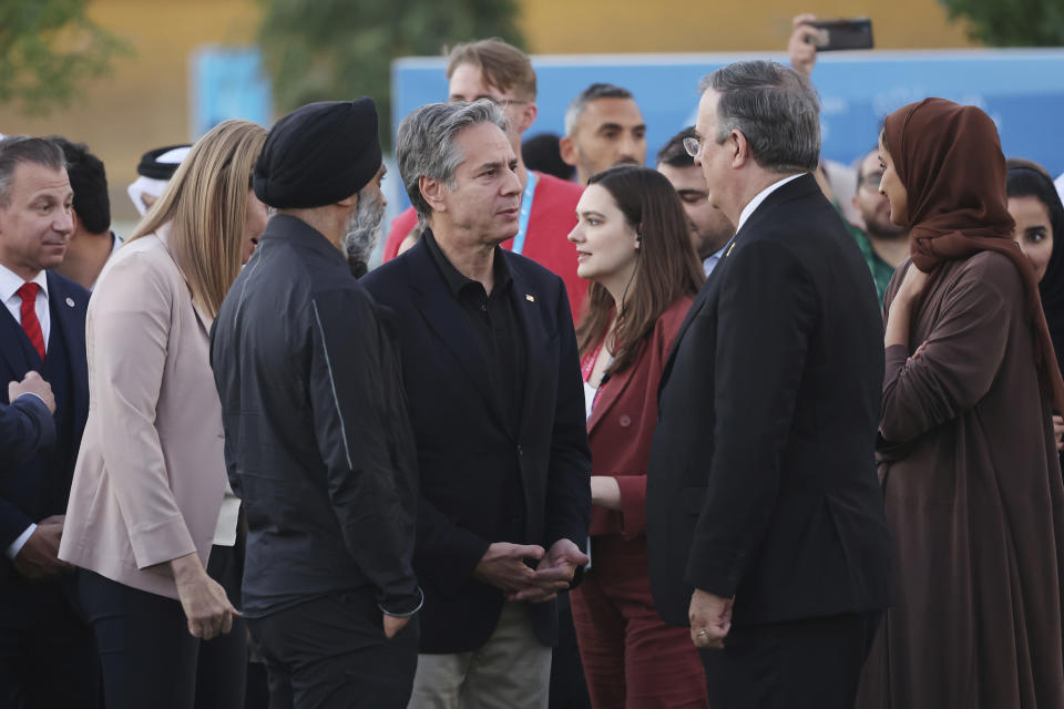 U.S. Secretary of State Anthony Blinken, center left, speaks with Mexico's Foreign Affairs Secretary Marcelo Ebrard, second right, and Canada's Minister of International Development Harjit Sajjan, third left, during a visit to Oxygen Park at Education City, in Doha Qatar, Monday, Nov. 21, 2022. (Karim Jaafar/Pool via AP)