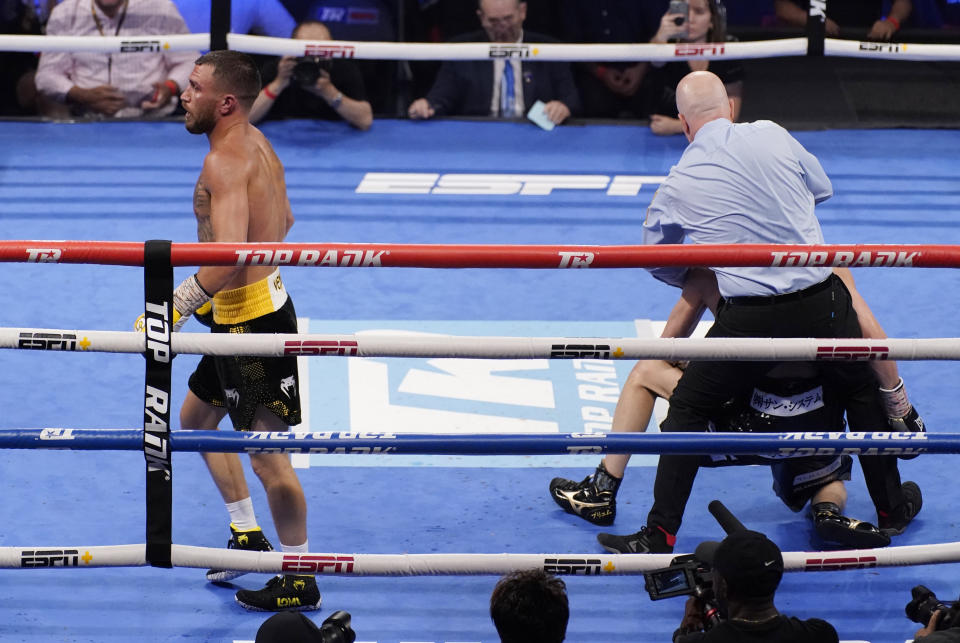 Vasiliy Lomachenko, of Ukraine, knocks down Masayoshi Nakatani, of Japan, during a lightweight bout Saturday, June 26, 2021, in Las Vegas. (AP Photo/John Locher)