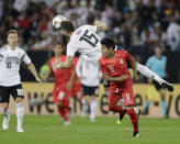 Germany's Niklas Suele, left, and Peru's Raul Mario Ruidiaz fight for the ball during a friendly soccer match between Germany and Peru in Sinsheim, Germany, Sunday, Sept. 9, 2018. (AP Photo/Michael Probst)