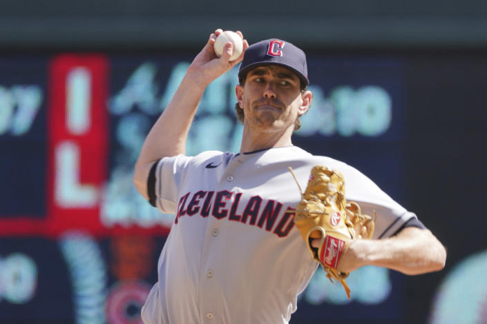 Cleveland Guardians pitcher Shane Bieber throws against the Minnesota Twins in the first inning of a baseball game, Sunday, Sept 11, 2022, in Minneapolis. (AP Photo/Jim Mone)