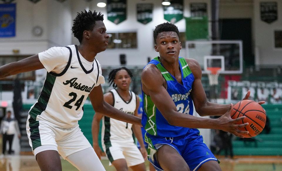 Providence Cristo Rey's Taviar Duerson, right, handles the ball while guarded by Arsenal's Devon Craig on Tuesday, Jan. 16, 2024, at Arsenal Technical High School.