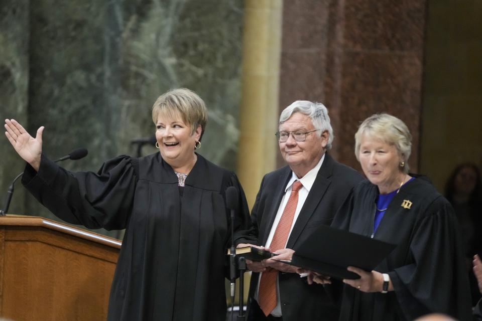 Janet Protasiewicz, left, is sworn as a Wisconsin Supreme Court justice by Supreme Court Justice Ann Walsh Bradley, Tuesday, Aug. 1, 2023, in Madison, Wis. At center is Protasiewicz' husband Greg Sell. (AP Photo/Morry Gash)