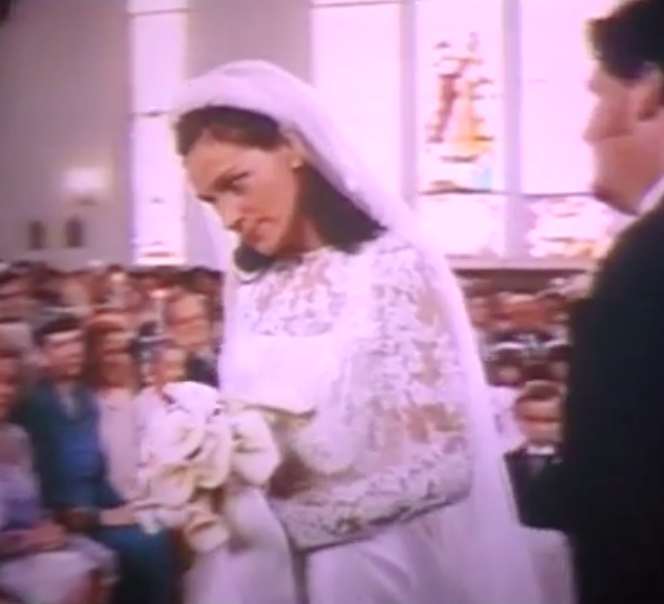 Maggie wearing a long-sleeve wedding dress