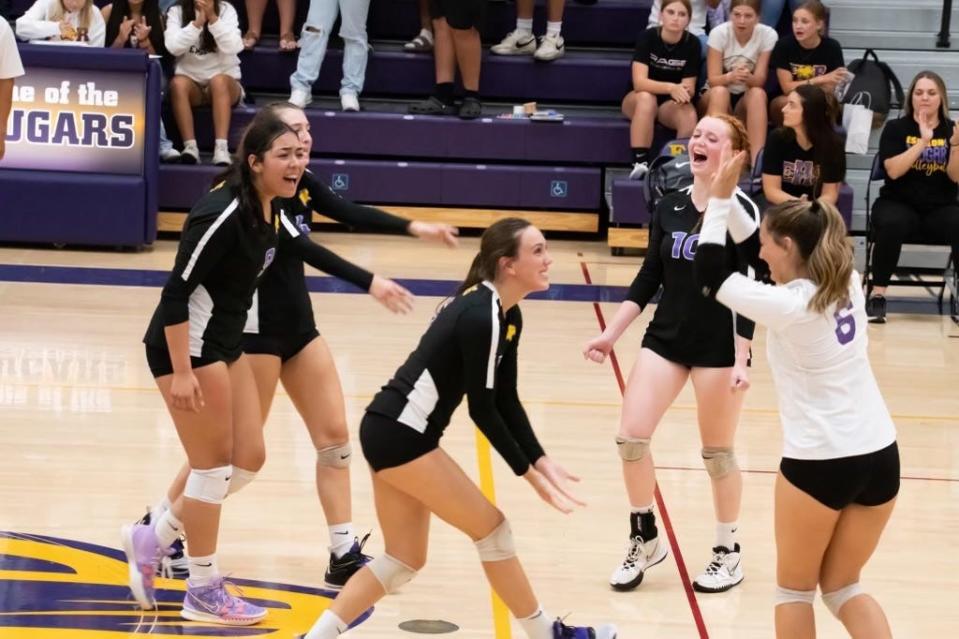 Escalon girls'' volleyball team celebrates after scoring a point at one of its home games in the 2022-23 season.