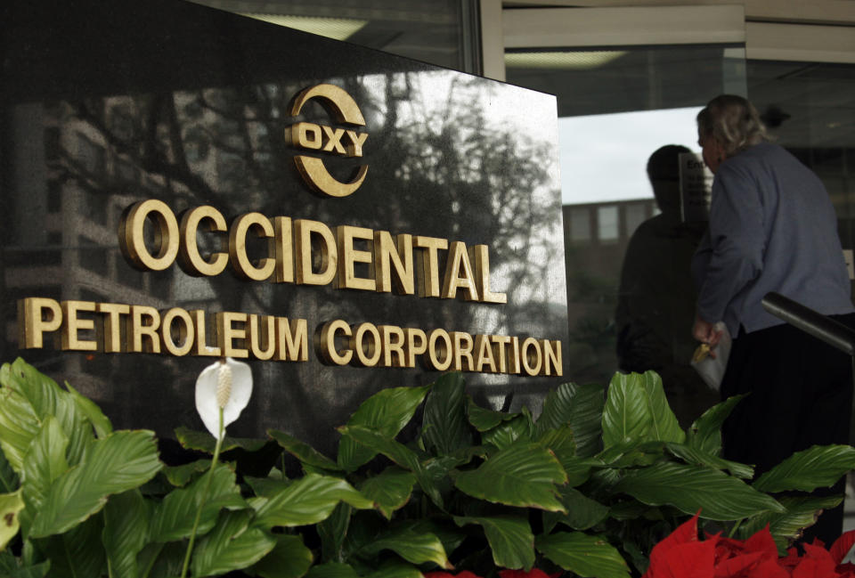 FILE - In this Jan. 29, 2010, file photo, an employee enters the Occidental Petroleum headquarters building in Los Angeles. Warren Buffett's company picked up another $368 million worth of Occidental Petroleum stock this week to give it control of nearly 21% of the oil producer. These are the first purchases Berkshire Hathaway has made since regulators gave it approval last month to buy up to 50% of Occidental, but since February Buffett has been consistently buying shares of the Houston-based company any time they drop below $60 apiece. (AP Photo/Reed Saxon, file)