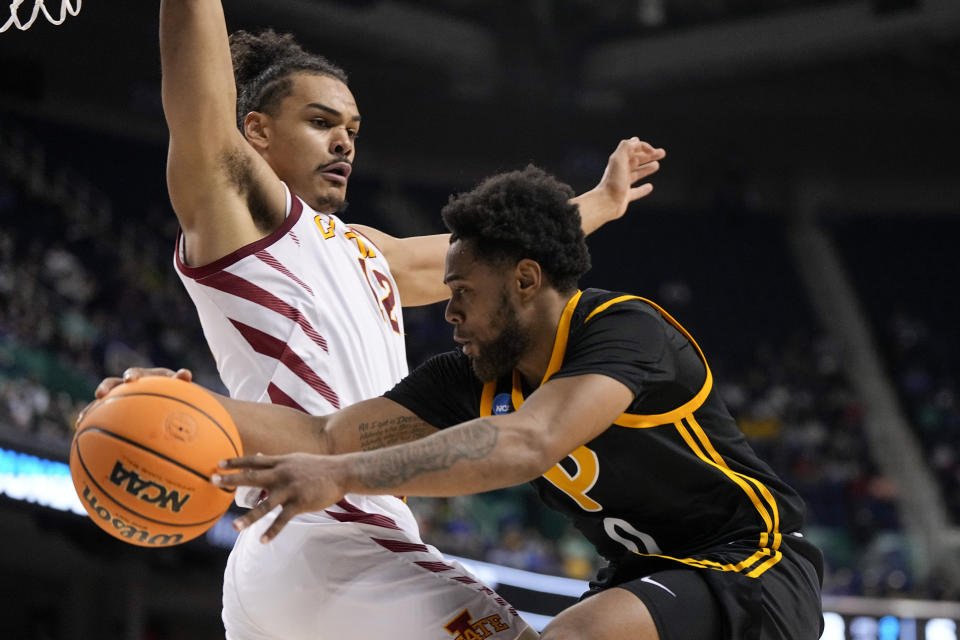 Pittsburgh guard Nelly Cummings passes around Iowa State forward Robert Jones during the first half of a first-round college basketball game in the NCAA Tournament on Friday, March 17, 2023, in Greensboro, N.C. (AP Photo/Chris Carlson)