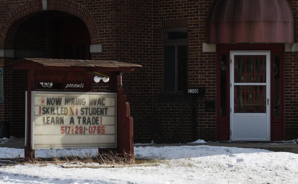 Signage seeking workers seen Tuesday, Jan. 11, 2022, at Brenner Heating and Cooling in Lansing.