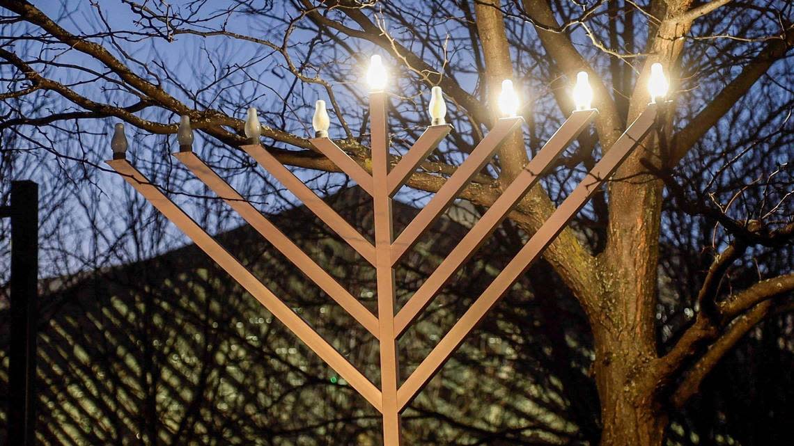 The third candle of a menorah at Triangle Park was lit during the third night of the second annual downtown Hanukkah Celebration on December 20, 2022.