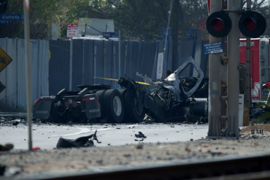 The tractor portion of a big rig is strewn on a road on Thursday, Feb. 15, 2024, in the Wilmington section of Los Angeles. (AP Photo/Eric Thayer)