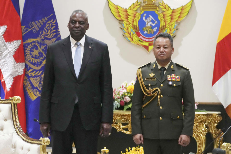 U.S. Defense Secretary Lloyd Austin, left, poses for photographs with Cambodian Defense Minister Tea Seiha at the Defense Ministry in Phnom Penh, Cambodia, Tuesday, June 4, 2024. Austin traveled to Cambodia on Tuesday to push for stronger military ties with China’s closest ally in Southeast Asia. (Heng Sinith/Pool Photo via AP)