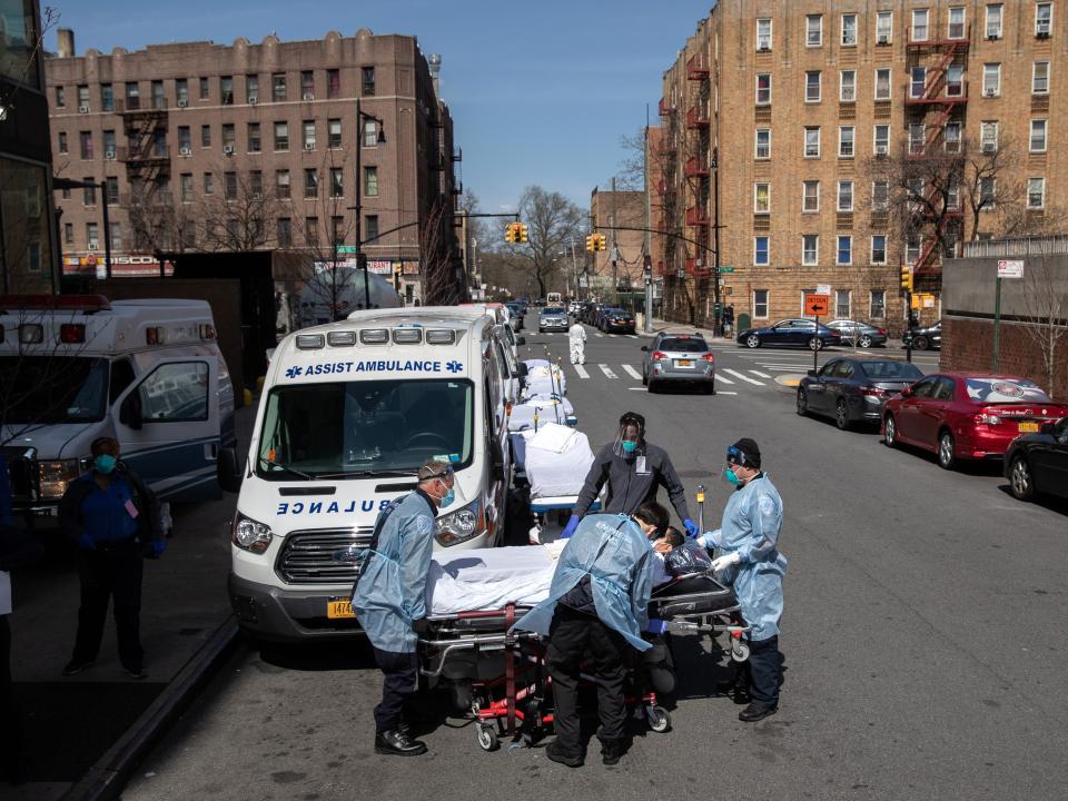 Medics and hospital workers prepare to lift a COVID-19 patient onto a hospital stretcher outside the Montefiore Medical Center Moses Campus on April 7, 2020 in the Bronx borough of New York City.