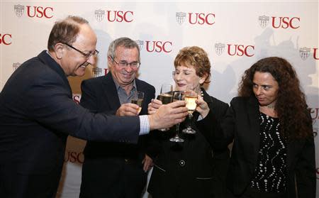 University of Southern California professor Arieh Warshel (2nd L) celebrates with his wife Tami Warshel (2nd R), daughter Yael Warshel (R) and USC President Max Nikias after winning the Nobel chemistry prize in Los Angeles California October 9, 2013. REUTERS/Lucy Nicholson