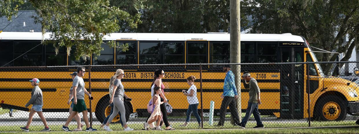 This photo shows children and families strolling toward the front entrance of Fruitville Elementary on the first day of school in August 2022. The Sarasota County School District is conducting a report of an alleged sexual battery of three students at the school.