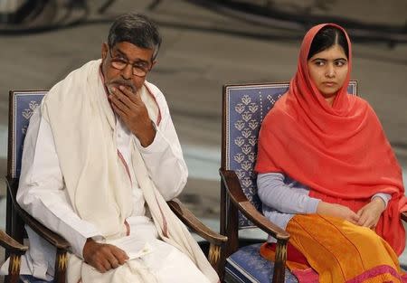 Nobel Peace Prize laureates Malala Yousafzai (R) and Kailash Satyarthi listen to speeches during the Nobel Peace Prize awards ceremony at the City Hall in Oslo December 10, 2014. REUTERS/Suzanne Plunkett