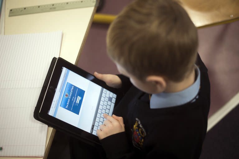 A student is seen using an iPad digital tablet at the British School of Paris, in Croissy-sur-Seine. Instead of textbooks, the pupils at the school are now pouring over tablet computers linked in to a wireless broadband network