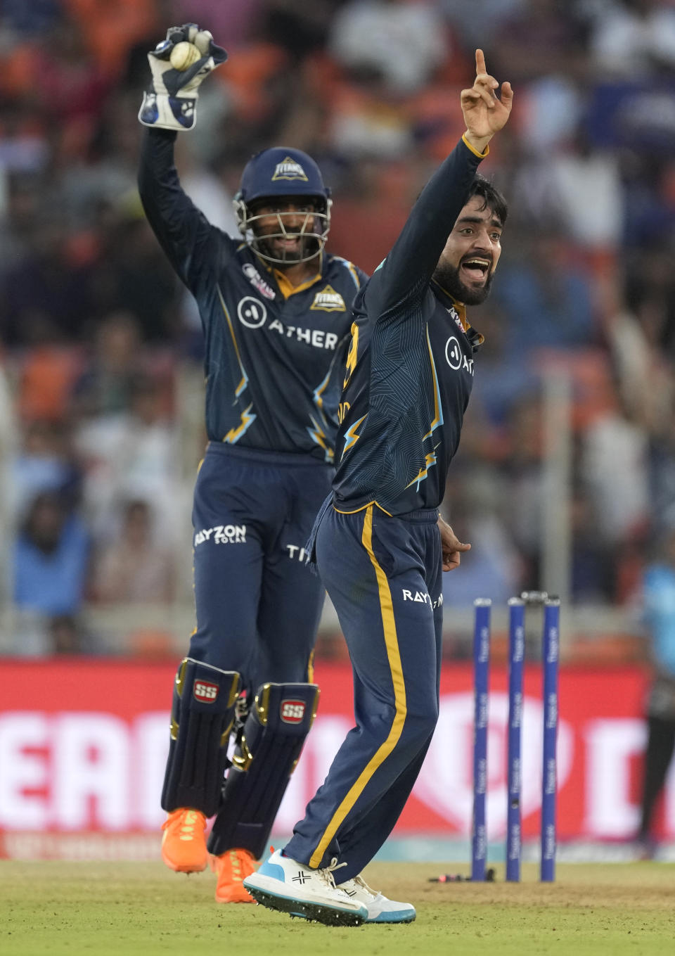 Gujarat Titans' Rashid Khan, right, appeals successfully for the wicket of Lucknow Super Giants' Quinton de Kock during the Indian Premier League cricket match between Gujarat Titans and Lucknow Super Giants in Ahmedabad, India, Wednesday, May 7, 2023. (AP Photo/Ajit Solanki)