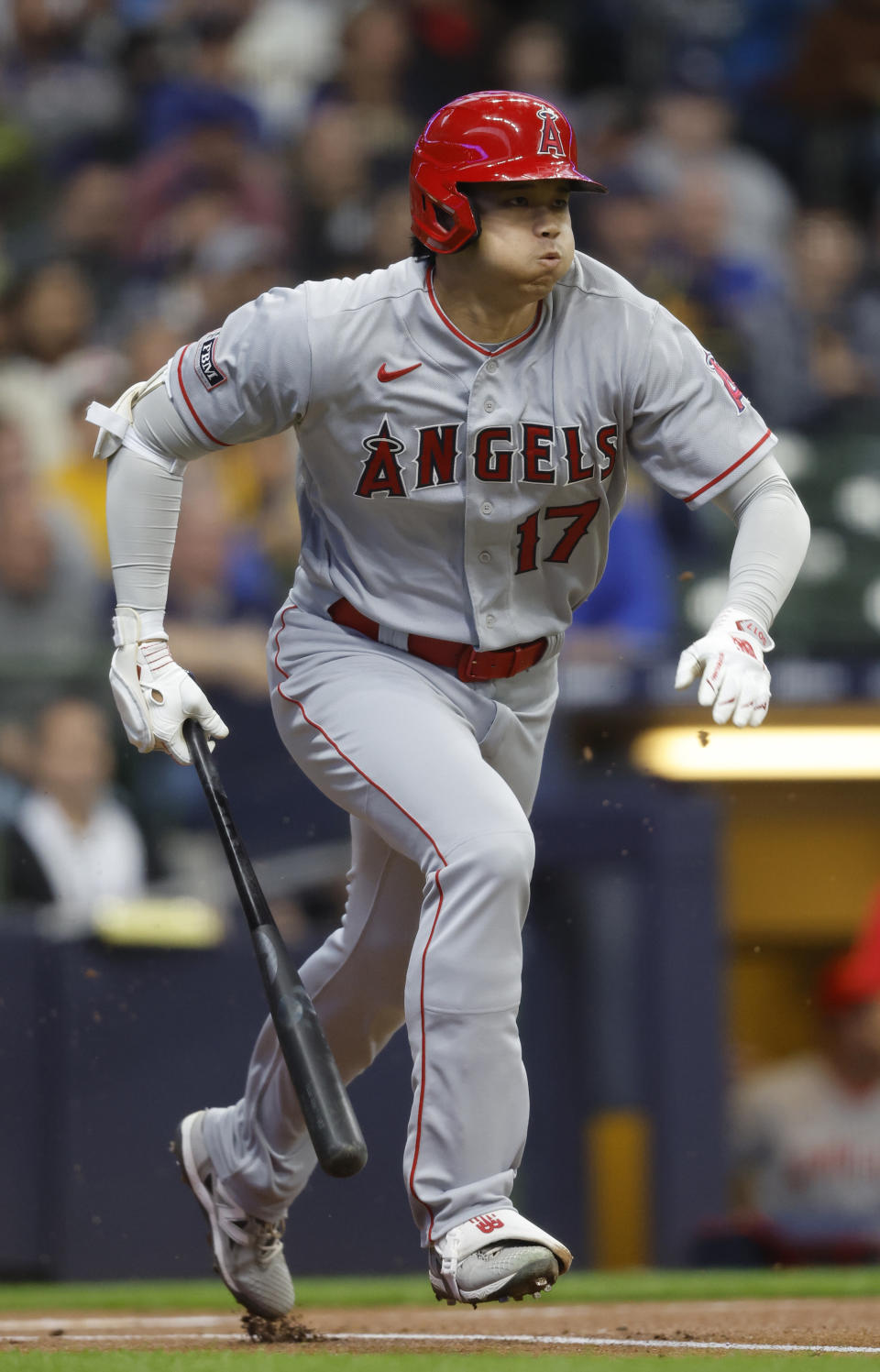 Los Angeles Angels designated hitter Shohei Ohtani heads toward first after hitting into a fielder's choice against the Milwaukee Brewers during the first inning of a baseball game Friday, April 28, 2023, in Milwaukee. (AP Photo/Jeffrey Phelps)