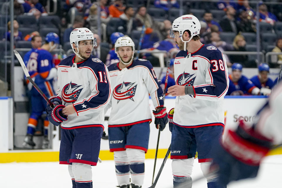 Columbus Blue Jackets left wing Johnny Gaudreau (13) and center Boone Jenner (38) converse during the second period of an NHL hockey game against the New York Isanders in Elmont, N.Y., Thursday, Dec. 7, 2023. (AP Photo/Peter K. Afriyie)