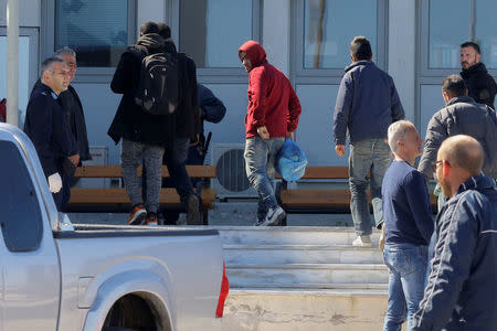 Undocumented migrants are transferred to the police headquarters after being arrested during an operation to dismantle an international smuggling ring at the city of Heraklion on the island of Crete, Greece, March 3, 2017. REUTERS/Stefanos Rapanis