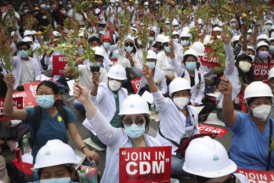 Students from the University of Medicine protest demonstrating by holding the brunches of Eugenia which is in the belief that the uprising is going to have succeeded, during an anti-coup protest in Mandalay, Myanmar, Sunday, Feb. 21, 2021. Police in Myanmar shot dead a few anti-coup protesters and injured several others on Saturday, as security forces increased pressure on popular revolt against the military takeover. (AP Photo)