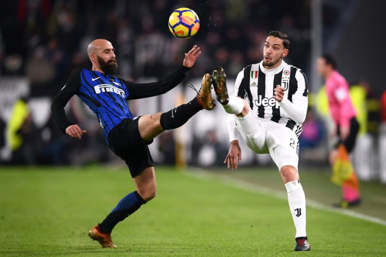 Inter Milan's Borja Valero (L) fights for the ball with Juventus' Mattia De Sciglio during their Italian Serie A match, at the Allianz stadium in Turin, on December 9, 2017