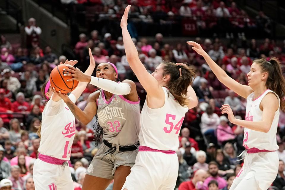 Ohio State's Cotie McMahon shoots between Indiana's Mackenzie Holmes (54) and Sara Scalia.