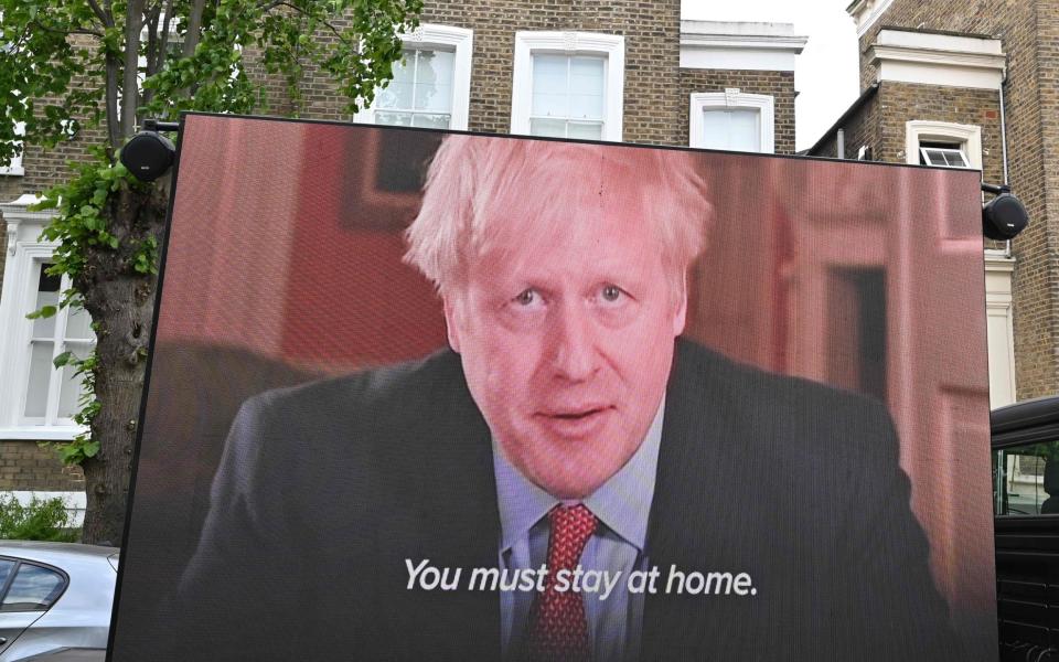 A big screen organised by British political campaign group Led By Donkeys mounted on a vehicle plays a clip from Britain's Prime Minister Boris Johnson's March 23 address to the nation where he explained the stay-at-home coronavirus lockdown rules outside the home of Number 10 Downing Street special advisor Dominic Cummings in London on May 24, 2020 - GETTY IMAGES