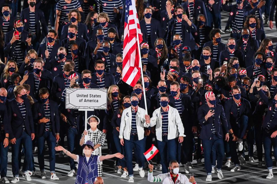 The athletes wore dark jackets and pants with striped shirts