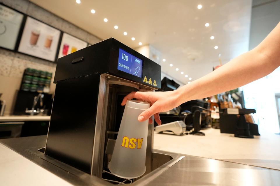 A reusable cup is washed at an Arizona State University Starbucks shop Wednesday, June 7, 2023, in Tempe, Ariz. At the store, there are bins around campus, and the cups are washed by the university — part of a partnership with Starbucks — and returned to the store. (AP Photo/Ross D. Franklin)