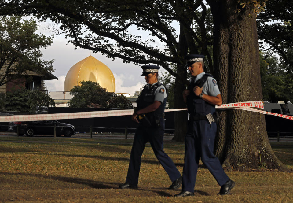 FILE - In this March 20, 2019, file photo, police officers patrol at a park outside the Al Noor mosque in Christchurch, New Zealand. On March 15, 2019, a gunman allegedly fueled by anti-Muslim hatred attacked two mosques in Christchurch, killing 51 people. (AP Photo/Vincent Yu, File)