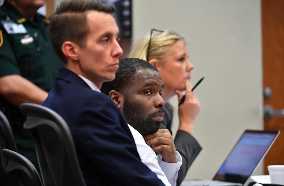 Tydarian Moore, center, sits with his attorneys Andrew Hibbert, left, and Colleen Glenn, during his trial Friday afternoon in Sarasota. Moore was found guilty of manslaughter with a firearm and possession of a firearm by a convicted felon for the killing of Antonio Wright in 2020.