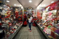 A youth looks at her mobile in a fan store at the Gothic quarter in Barcelona, Spain, August 18, 2015. REUTERS/Albert Gea