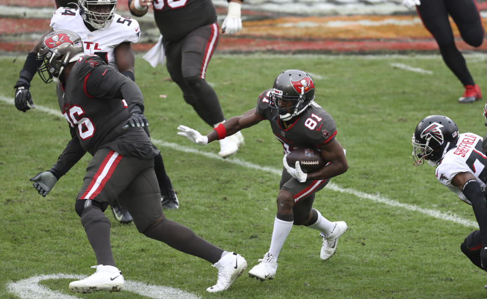 Tampa Bay Buccaneers wide receiver Antonio Brown (81) follows a block by offensive tackle Donovan Smith (76) during the second half of an NFL football game against the Atlanta Falcons Sunday, Jan. 3, 2021, in Tampa, Fla. (AP Photo/Mark LoMoglio)