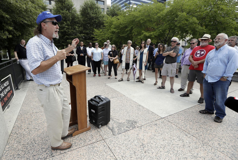 Ray Krone, left, who was the 100th inmate exonerated from death row since the death penalty was reinstated, speaks during a protest against the death penalty Tuesday, Aug. 7, 2018, in Nashville, Tenn. Attorneys are asking the U.S. Supreme Court for a stay of execution for convicted child killer Billy Ray Irick after the Tennessee Supreme Court and governor decided against a delay.(AP Photo/Mark Humphrey)