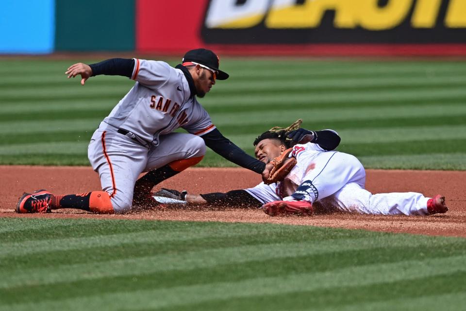 San Francisco Giants second basemen Thairo Estrada tags out Cleveland Guardians' Jose Ramirez in the first inning of a baseball game, Sunday, April 17, 2022, in Cleveland. Ramirez tried to stretch a single into a double. (AP Photo/David Dermer)