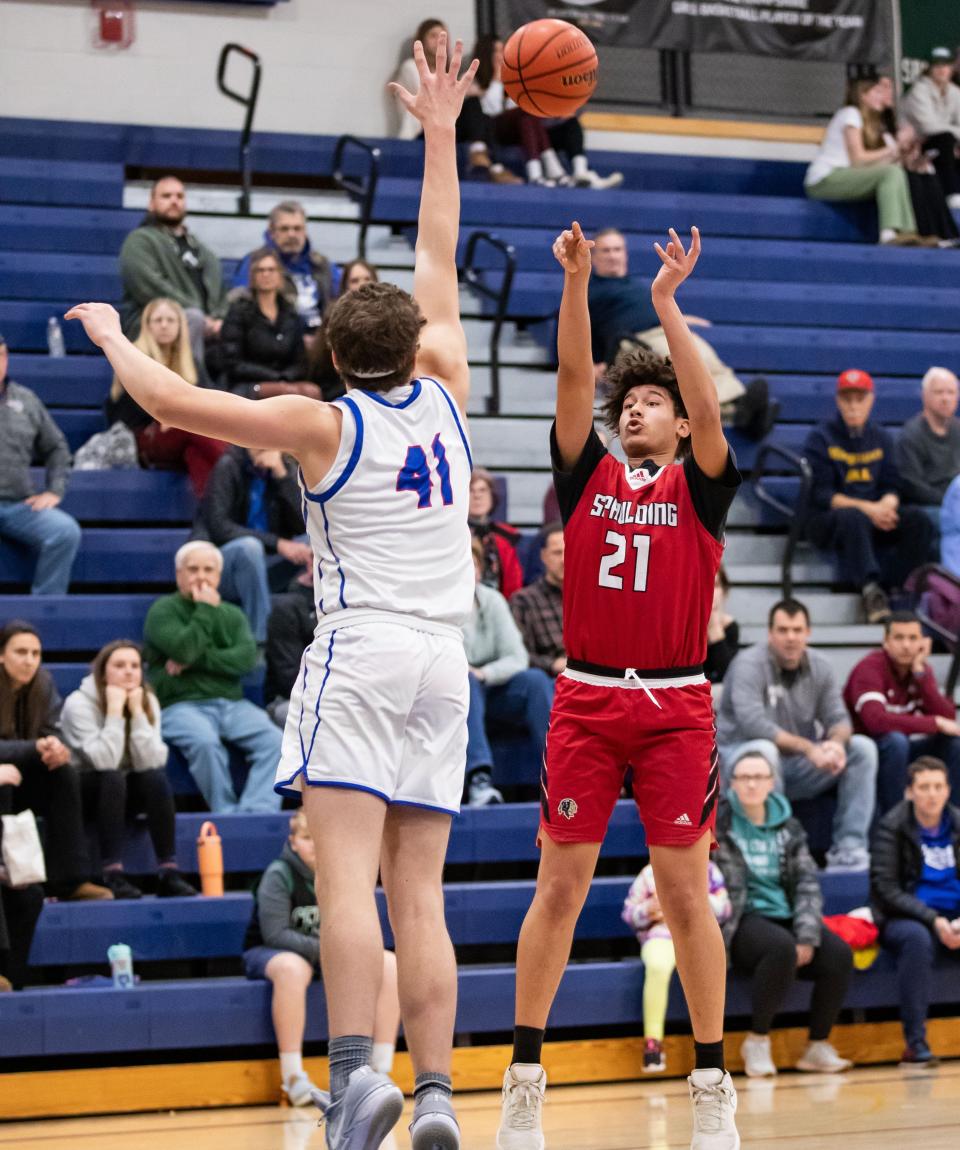 Spaulding's Nate Sanchez-Martinez takes a shot over Winnacunnet's Andrew Simmons during Tuesday's Division I boys basketball game in Hampton. Spaulding won 53-41.