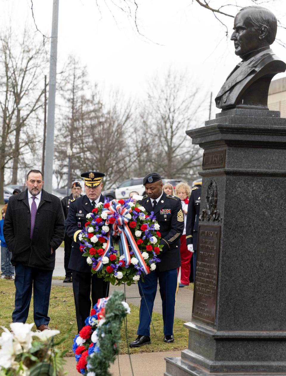 U.S. Army Reserve Maj. Gen. Matthew Baker, left, and Sgt. Maj. James Flemister, both of the 88th Readiness Division, lay a wreath at the McKinley Memorial on behalf of President Joe Biden in Canton Saturday.