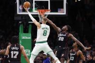 Boston Celtics' Kristaps Porzingis (8) shoots against Detroit Pistons' Isaiah Stewart (28) during the first half of an NBA basketball game, Monday, March 18, 2024, in Boston. (AP Photo/Michael Dwyer)