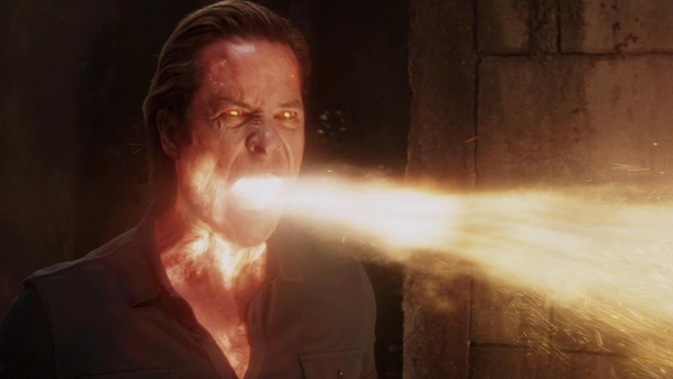 A man glowing red breathes fire out of his mouth in Iron Man 3