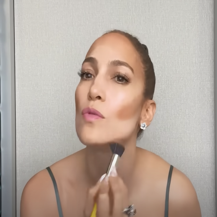 Jennifer Lopez applying makeup