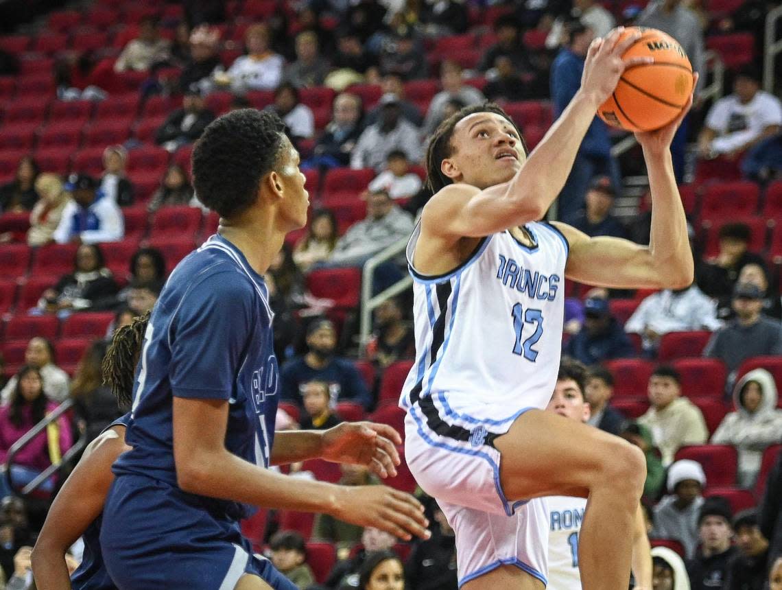 Clovis North’s Jaylen Bryant goes to the hoop while guarded by Bullard’s Kyshawn Johnson in the championship game of Valley Children’s Tip-Off Invitational at the Save Mart Center on Saturday, Dec. 3, 2022. Clovis North defeated Bullard 75-54.
