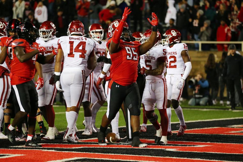 Texas Tech Red Raiders defensive tackle Jaylon Hutchings (95) reacts after scoring a touchdown against the Oklahoma Sooners in the first half at Jones AT&T Stadium and Cody Campbell Field.