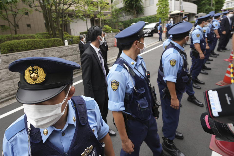 Police officers stand guard in front of the residence of Japan's former Prime Minister Shinzo Abe Saturday, July 9, 2022, in Tokyo. The body of Japan’s former Prime Minister Shinzo Abe was returned to Tokyo on Saturday after he was fatally shot during a campaign speech in western Japan a day earlier.(AP Photo/Eugene Hoshiko)