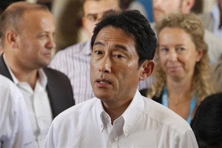 Japanese Foreign Minister Fumio Kishida (C) speaks to the media during his visit with U.N. High Commissioner for Refugees (UNHCR) Antonio Guterres (not in picture) to Al Zaatri refugee camp, in the Jordanian city of Mafraq, near the border with Syria, July 26, 2013. REUTERS/Muhammad Hamed