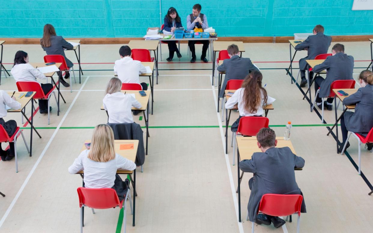 Pupils taking an exam - Juice Images