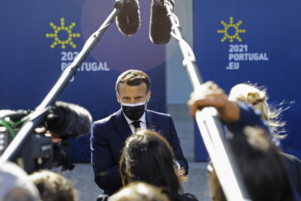 French President Emmanuel Macron speaks with the media as he arrives for an EU summit at the Crystal Palace in Porto, Portugal, Saturday, May 8, 2021. On Saturday, EU leaders hold an online summit with India's Prime Minister Narendra Modi, covering trade, climate change and help with India's COVID-19 surge. (Violeta Santos Moura, Pool via AP)
