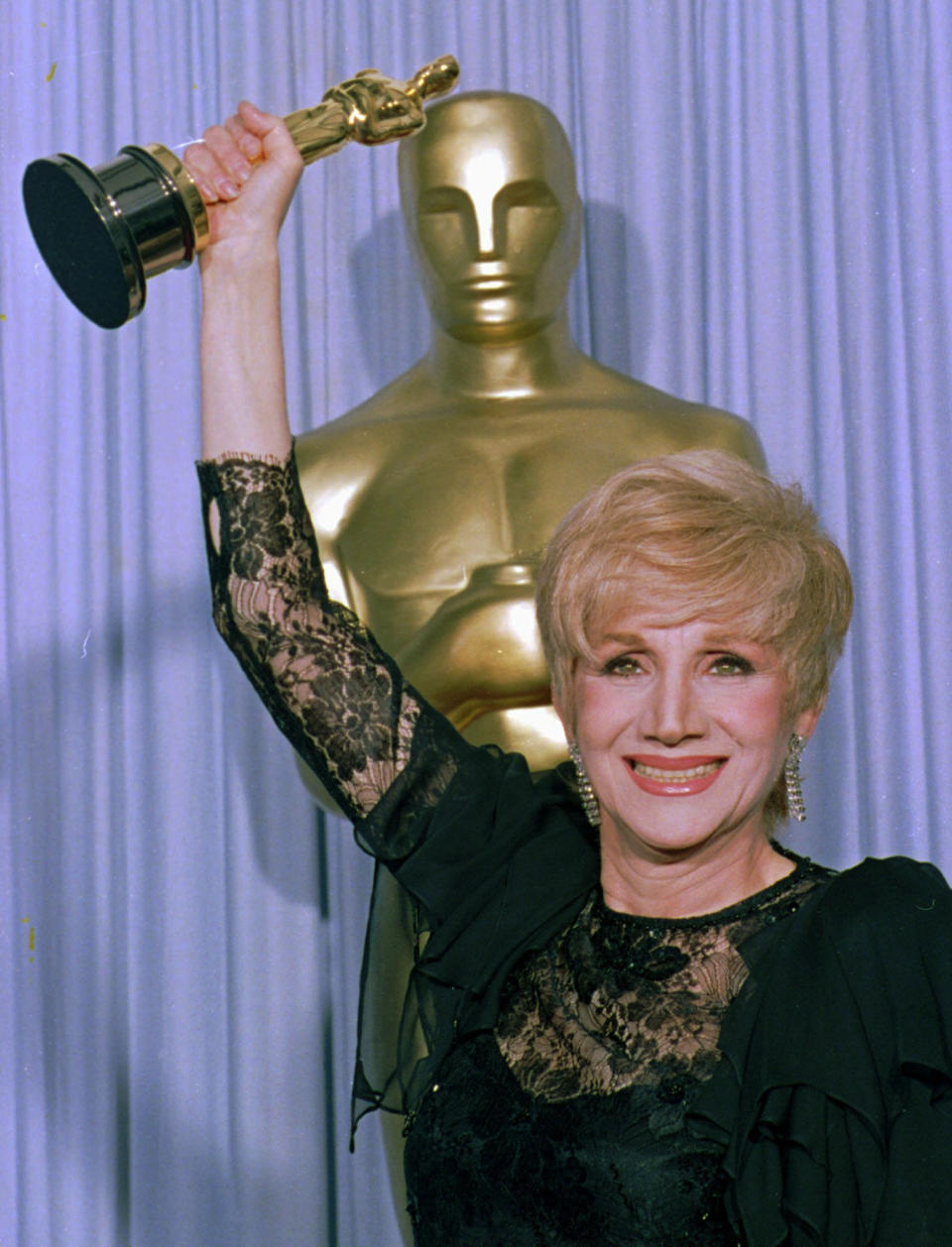 FILE - In this April 11, 1988 file photo, Olympia Dukakis holds her Oscar at the Shrine Auditorium in Los Angles after being honored at the 60th Academy Awards as best supporting actress for her role in "Moonstrck." Olympia Dukakis, the veteran stage and screen actress whose flair for maternal roles helped her win an Oscar as Cher’s mother in the romantic comedy “Moonstruck,” has died. She was 89. (AP Photo/Lennox Mcleondon, File)